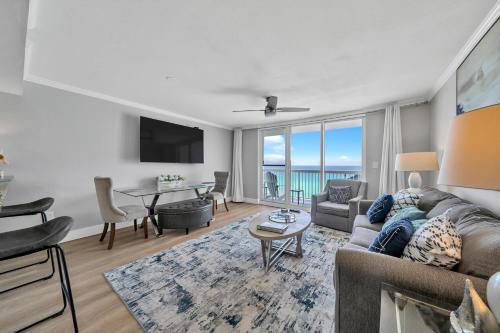 a living room with a couch and a table at Pelican Beach Resort by Colasan in Destin