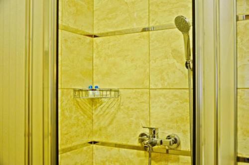 a shower in a bathroom with a faucet at Yesilirmak Aparts Hotel in Istanbul