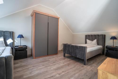 a bedroom with a bed and a couch at Hotel CityHome am Kurpark in Bad Salzuflen