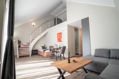 a living room with a couch and a table at Hotel CityHome am Kurpark in Bad Salzuflen