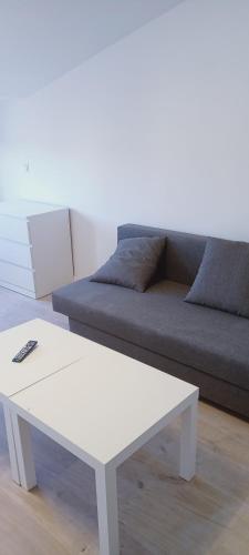 a white coffee table in a living room with a couch at BudgetBnb 283, vue dégagée pour ce joli studio in La Seyne-sur-Mer