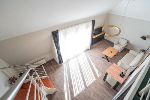 an overhead view of a living room with a window at Hotel CityHome am Kurpark in Bad Salzuflen