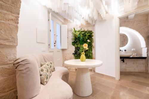 a living room with a couch and a table at La Mandorla Luxury Trullo in Alberobello