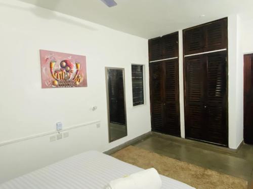 a bedroom with a bed and a picture on the wall at Sea whispers in Mombasa