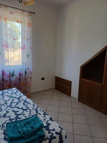 a bedroom with a bed and a window and a tv at Campo del Gatto in Viterbo