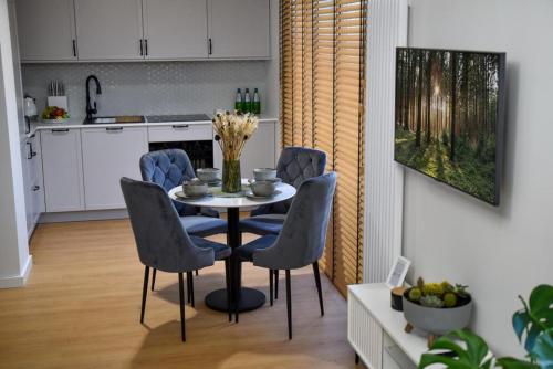 a dining room with a table and chairs in a kitchen at Benefis Tatarska in Przemyśl