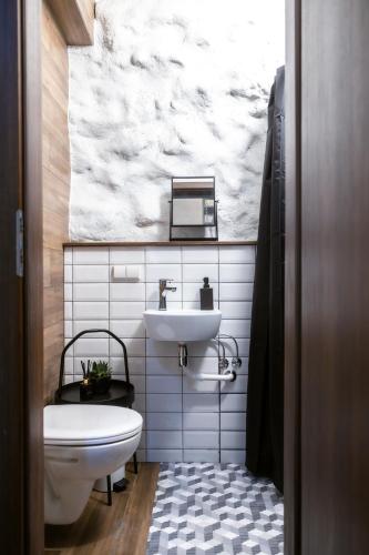 a bathroom with a sink and a toilet at BDSM Black Apartments in Vilnius