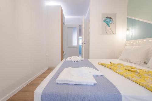 a bedroom with a bed with a towel on it at Little gem by the sea in Chania