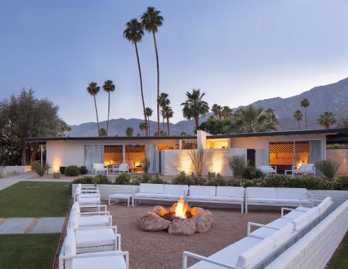 a backyard with white lounge chairs and a fire pit at L'Horizon Resort & Spa, Hermann Bungalows in Palm Springs