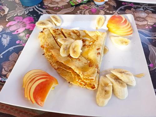 a white plate with two slices of fruit on it at Cinderella Camp Nuweiba in Nuweiba