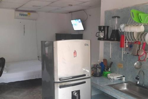 a kitchen with a stainless steel refrigerator and a sink at Home Puerto carreño vichada in Cerro el Bita