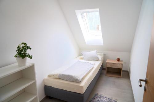 Aischtal Ferienwohnung tesisinde bir odada yatak veya yataklar