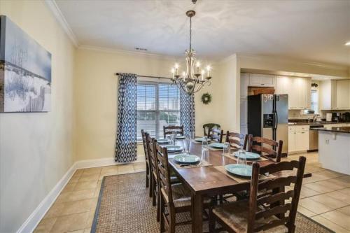 a dining room with a table and chairs and a kitchen at Ocean View Luxury Rental - Sleeps 16 in Myrtle Beach
