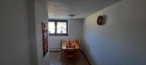 a dining room with a table and chairs and a window at Privát Tatry Štrba in Štrba