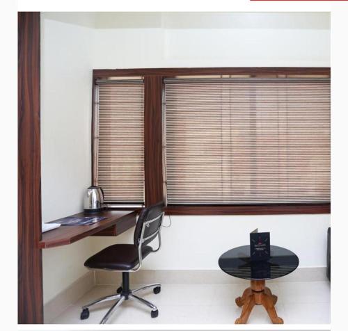 an office with a desk and a chair and a table at Triple Tree Hotel & Resorts in Bhubaneshwar