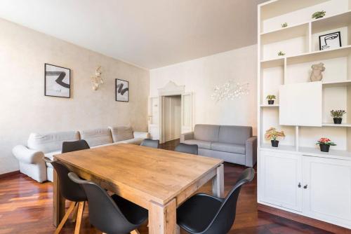 a living room with a wooden table and chairs at [Vista sulla Basilica] in Mantova