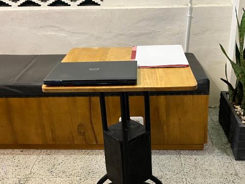 a table with a laptop on top of a bed at Hotel O Kost Maharaja Near Maros in Makassar