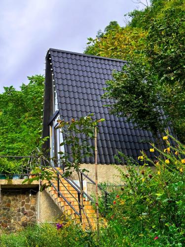 a black roof on top of a house at N STORY in Keda