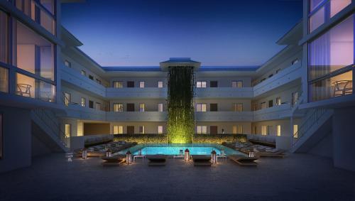 a large building with a water fountain in the middle at Beach Haus Key Biscayne Contemporary Apartments in Miami