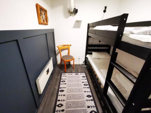 a room with two bunk beds and a chair at Abisko Guesthouse & Activities in Abisko