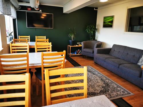 a living room with a table and chairs and a couch at Abisko Guesthouse & Activities in Abisko