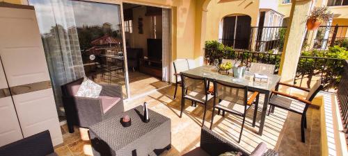 a balcony with a table and chairs on a balcony at Casa Palmu apartment - A peaceful and relaxing oasis in Golf del Sur, Tenerife in San Miguel de Abona