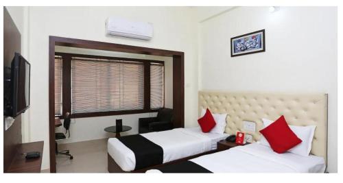 a hotel room with two beds and a window at Triple Tree Hotel & Resorts in Bhubaneshwar