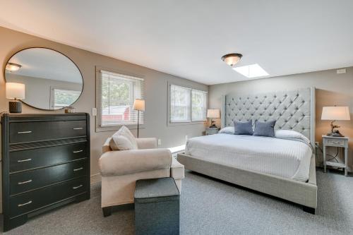 a bedroom with a bed and a chair and a mirror at Maggie Valley Home about 5 Mi to Cataloochee Ski Area! in Maggie Valley