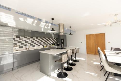 a kitchen with a counter and a table and chairs at The Mayfair in Six Mile Bottom