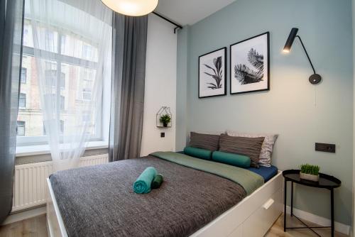 a bedroom with a bed with a blue pillow on it at Apartment in Vilnius Center in Vilnius