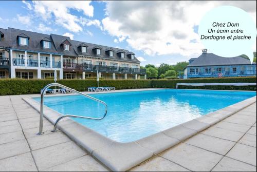 a large swimming pool in front of a building at *A setting between Dordogne and swimming pool* in Argentat