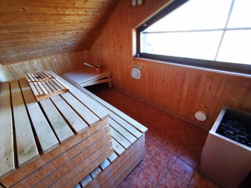 an attic room with a bed and a window at Abisko Guesthouse & Activities in Abisko