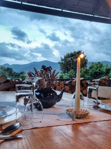 a table with a candle on a table with chairs at Guest Accommodation Butina in Kuterevo