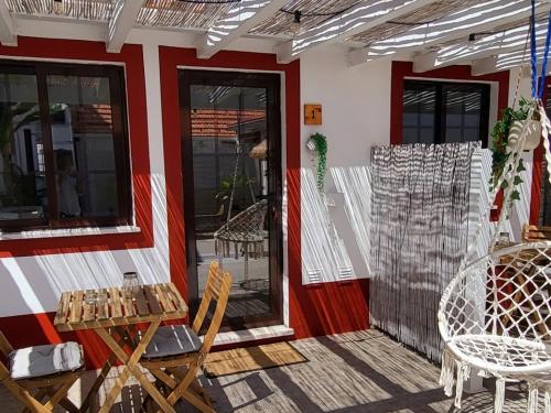 a patio with a table and chairs on a building at Cantinho de Milfontes 2 in Vila Nova de Milfontes