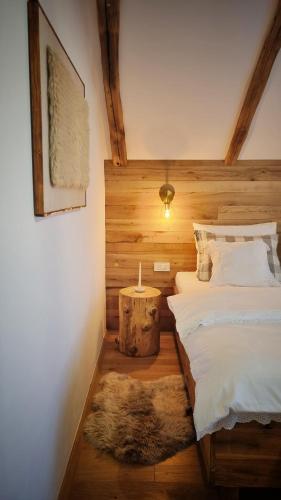 a bedroom with a large bed and a rug at Guest Accommodation Butina in Kuterevo