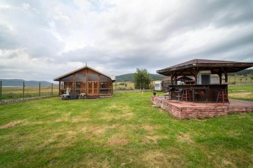 a gazebo and a house in a field at Madjestic Houses in Batak