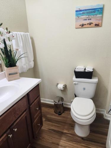 a bathroom with a toilet and a sink at Spacious Villa close to the beach, 10 sleeps in Galveston