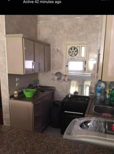 a small kitchen with a stove and a sink at شقة بكفر الشيخ in Disūq