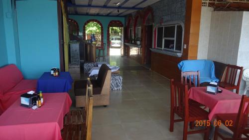 a restaurant with two tables and chairs with pink tables at Playa El Obipo C La Marea building La Libertad in La Libertad