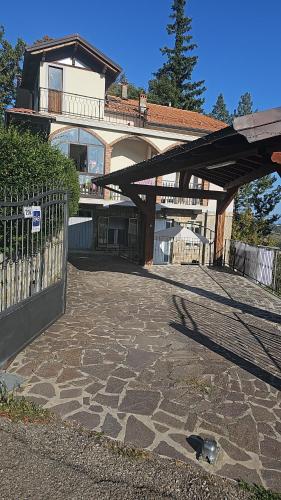 a cat sitting on the ground in front of a building at Lina's bed and breakfast in Montese