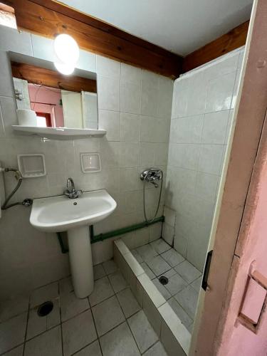 a bathroom with a sink and a shower at Selena Rooms in Agia Galini