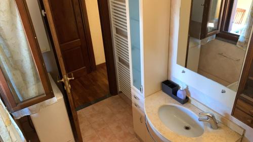 a bathroom with a sink and a mirror at Il Cielo di Lucio in Pisa