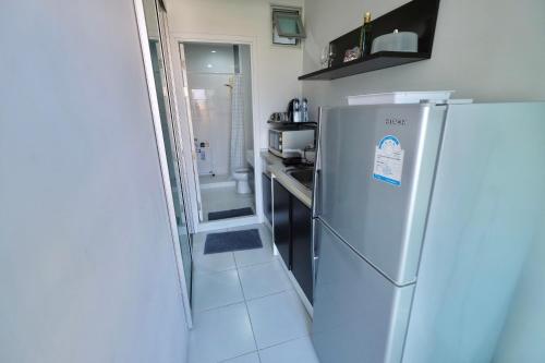 a kitchen with a refrigerator and a sink at 7min BKK airport - free pick up - malls nearby in Bangkok