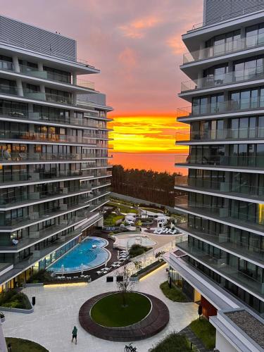 a view of a building with a sunset in the background at Your Holidays Waves in Międzyzdroje