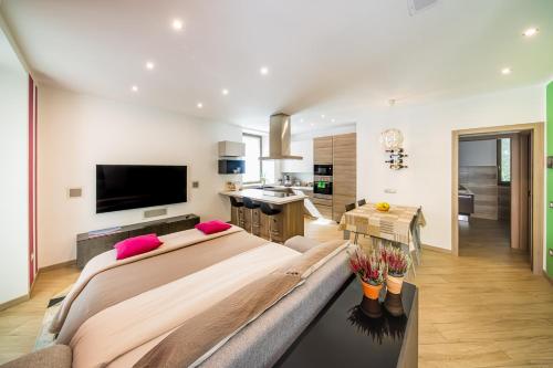 a large bedroom with a large bed and a kitchen at Luna Nuova in Tirano