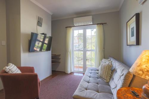 a living room with a couch and a window at Hotel Palazzo Reale in Campos do Jordão