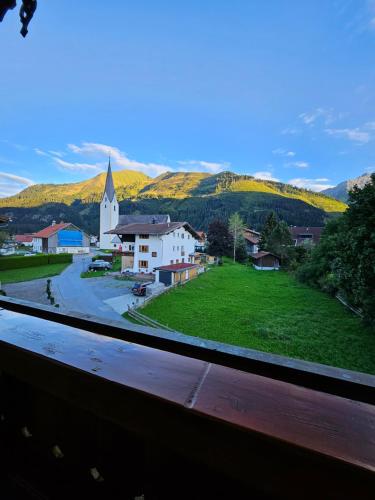 a view of a small village with a church at am Mühlbach - Ferienwohnungen Luttinger in Bichlbach