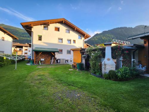 a house with a green yard in front of it at am Mühlbach - Ferienwohnungen Luttinger in Bichlbach