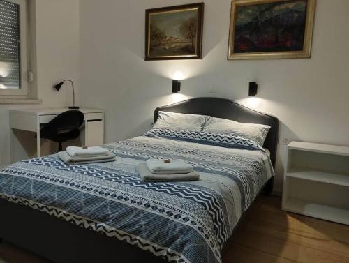 a bedroom with a bed with two towels on it at Lovely flat, city center with free parking in Varaždin