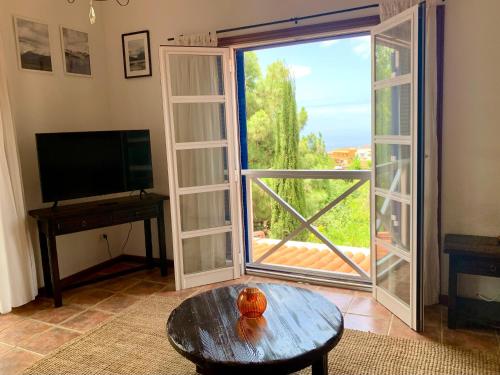 a living room with a large window and a tv at Stilvolle Villa in Teneriffa Süd in Arona
